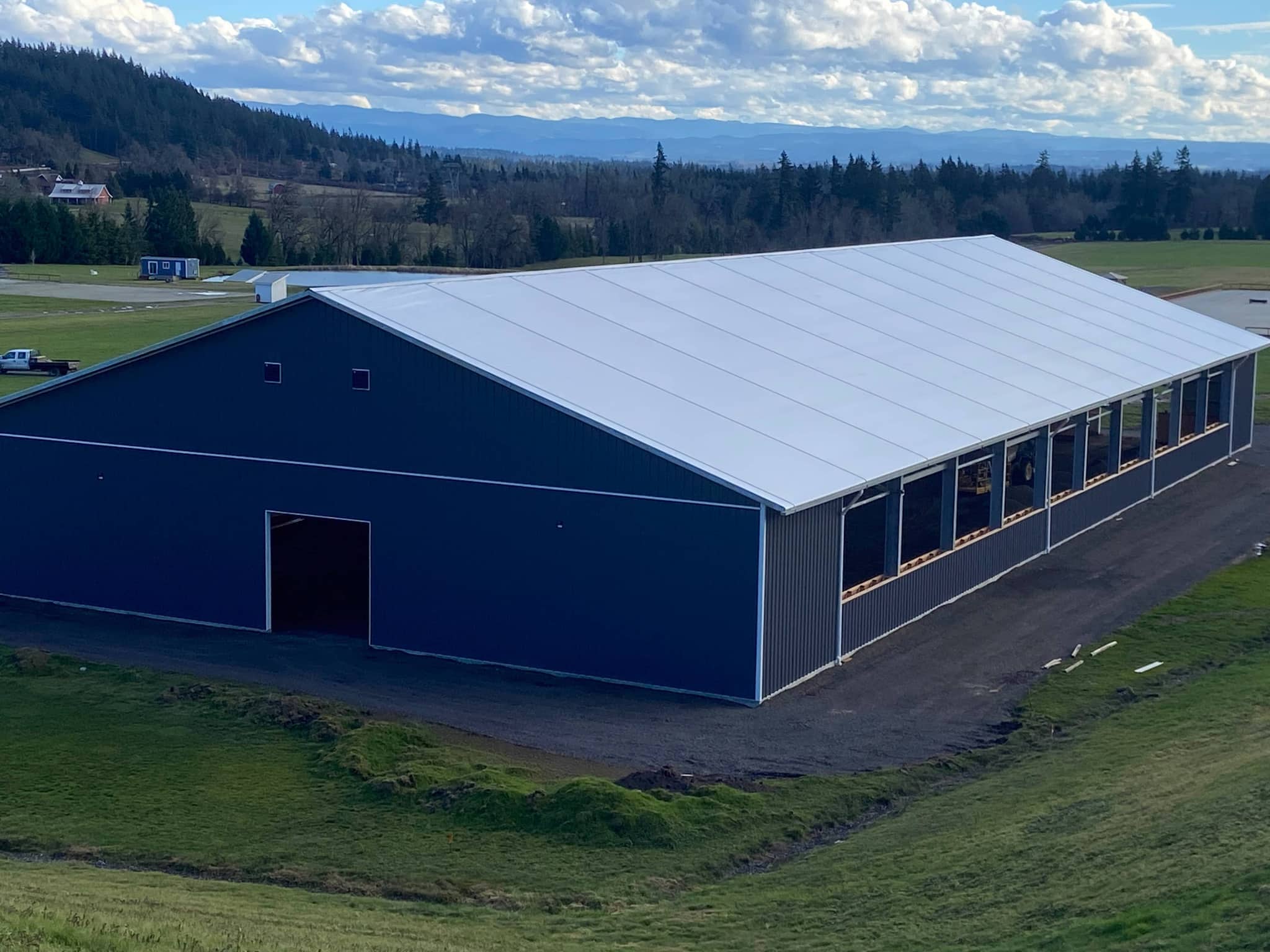 Aerial view of barn and surrounding hills