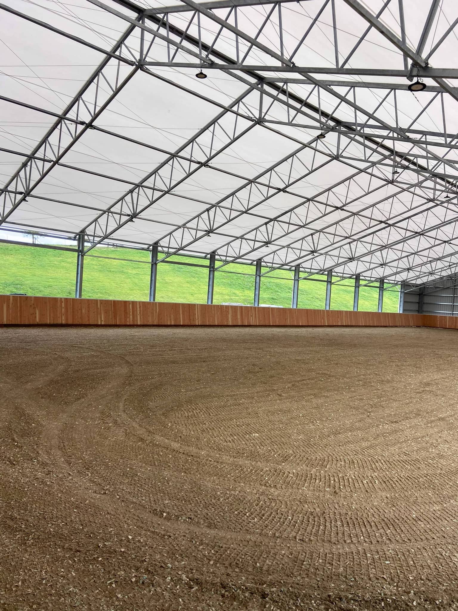 Outdoor arena with white fencing at Hidden Creek